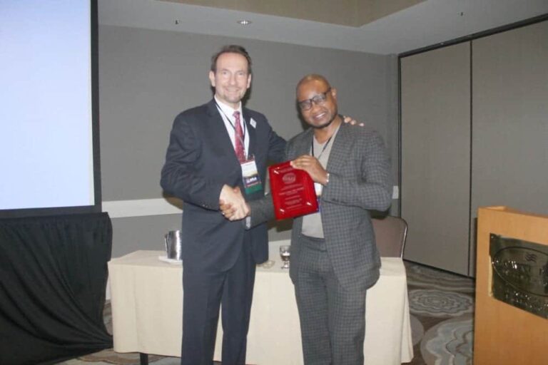 The ISHRS president, Dr. Ken Washenik presents Dr. Umar an award to recognize  his commitment to educational excellence at the 2017 ISHRS regional workshop in Los Angeles, CA