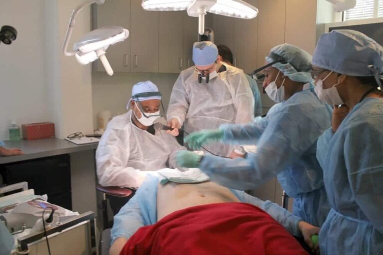 Dr. Umar demonstrating to his ISHRS colleagues the applications of his Dr.UPunch Rotor intelligent ™ instrumentation to perform safe extractions of body hair grafts for a real patient case