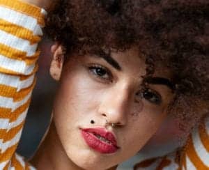 Model with a mole, also known as a beauty mark on her top upper lip.*